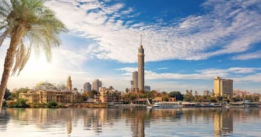 View of Cairo Tower rising above the city skyline with the Nile River in the foreground